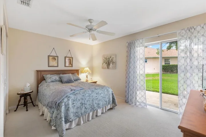 Second bedroom with sliding doors leading out to patio.