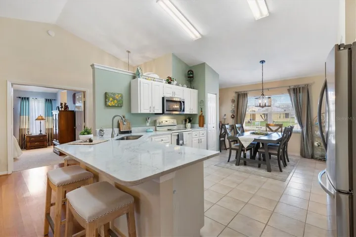 Eat-in Kitchen with tile floors, high ceilings.