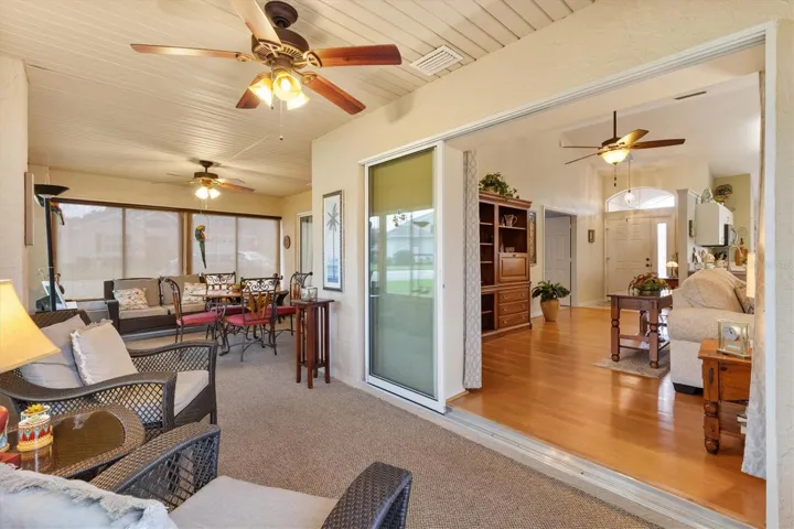 Carpeting in Florida room with new windows, sliding glass doors recede into wall.