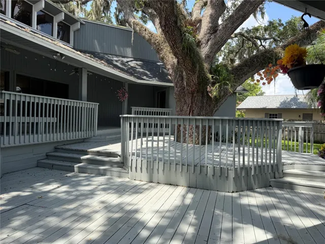 Tiered deck surrounding oak tree