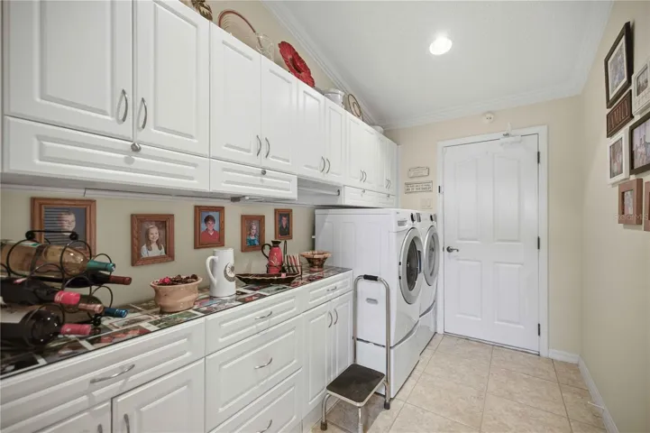 Inside Laundry with plenty of storage and a sink.