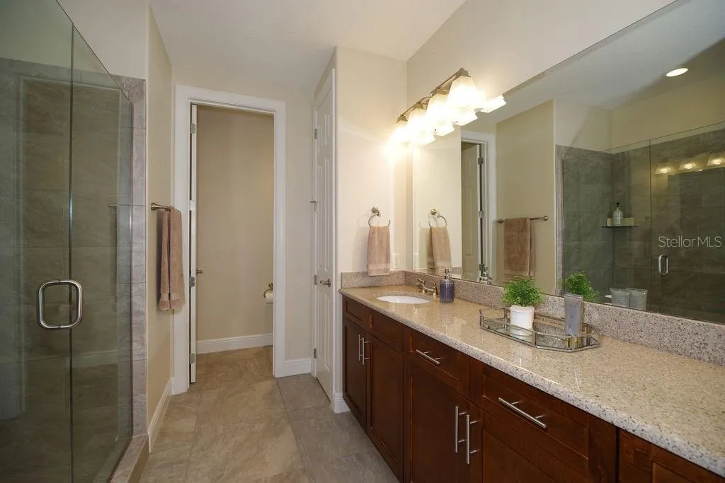 PRIMARY BATHROOM WITH DUAL SINKS AND SHOWER