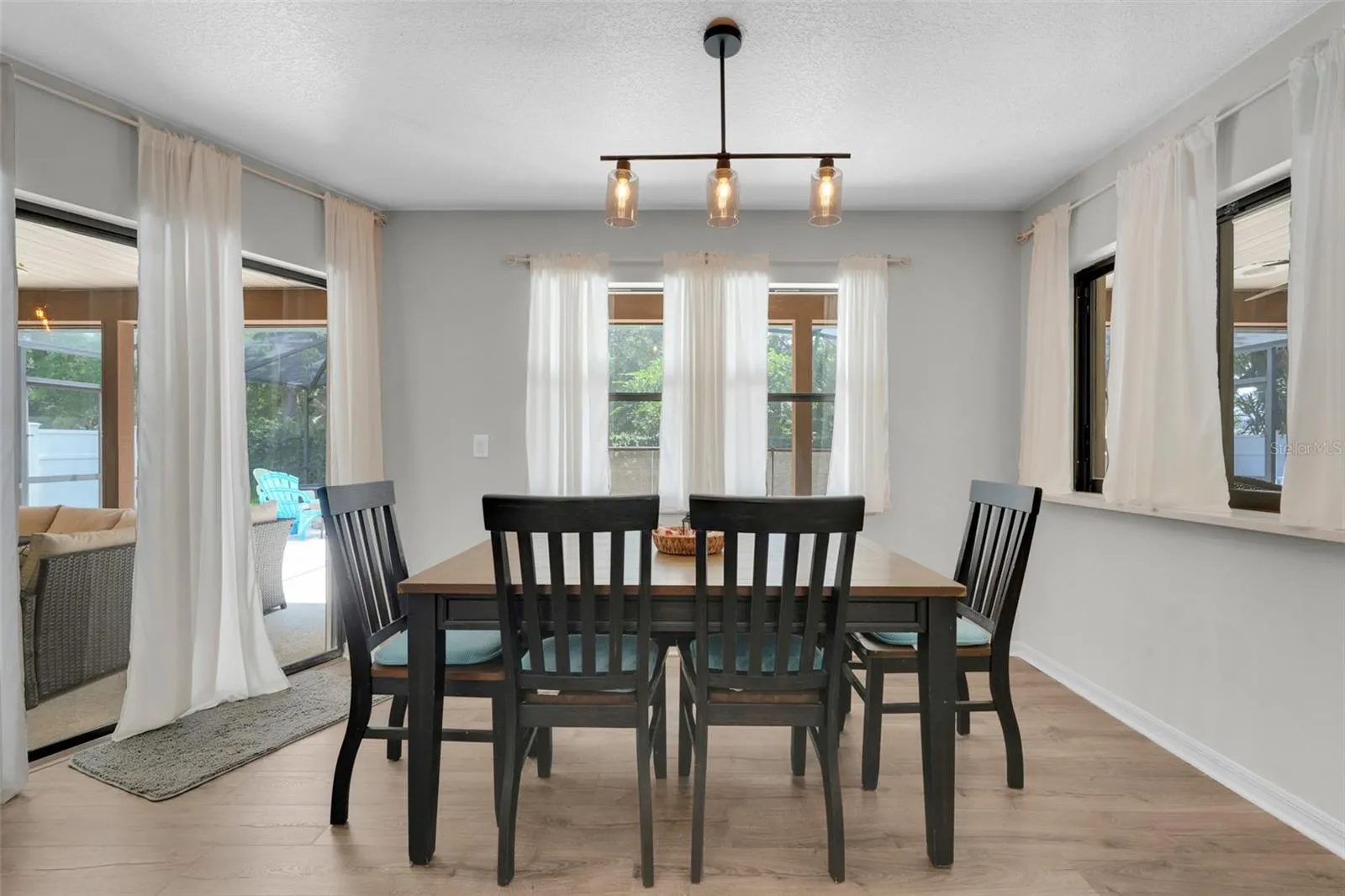 Dinette area off the kitchen with a large pass through window to pool area