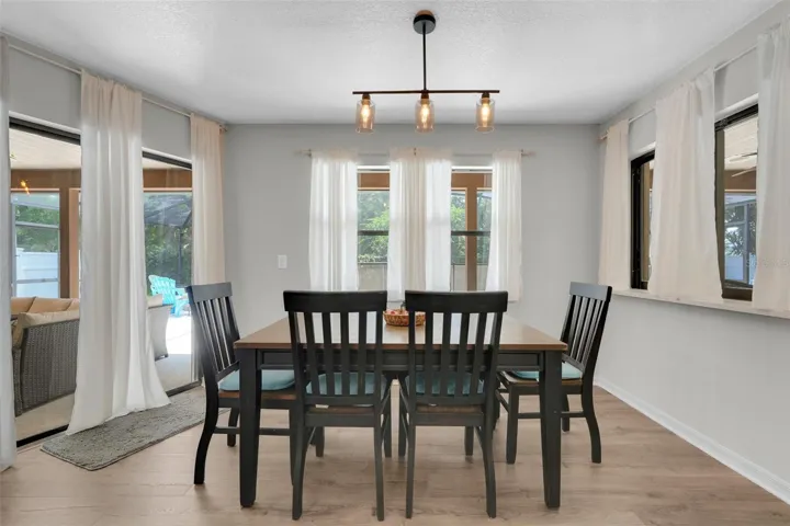 Dinette area off the kitchen with a large pass through window to pool area