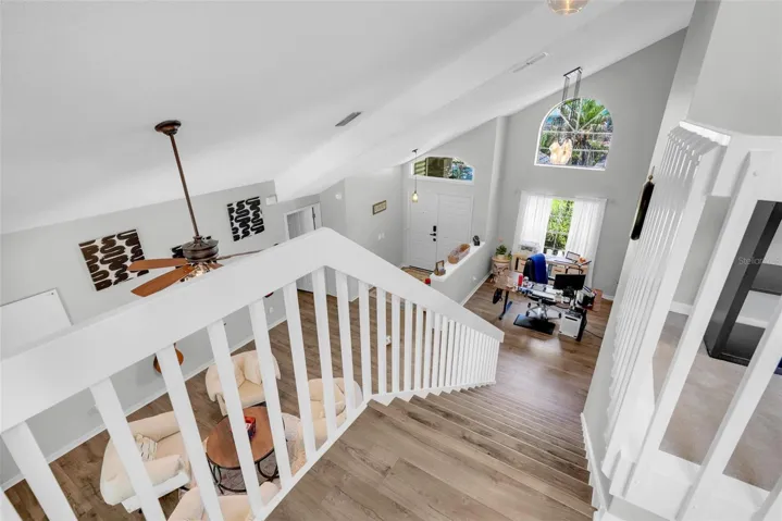 Beautiful open staircase with luxury vinyl flooring leading to the upstairs 3 bedrooms