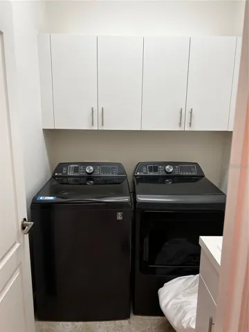 Laundry Room with full sized washer/dryer and utility sink
