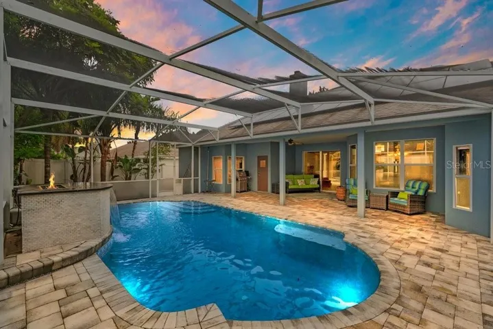 Virtially Staged Twilight Paver Deck and Screen In Pool with Water / Fire Feature