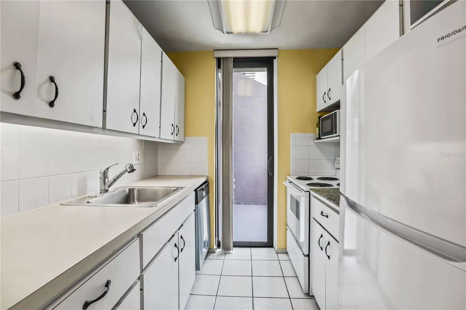 Galley kitchen with sliding door to balcony