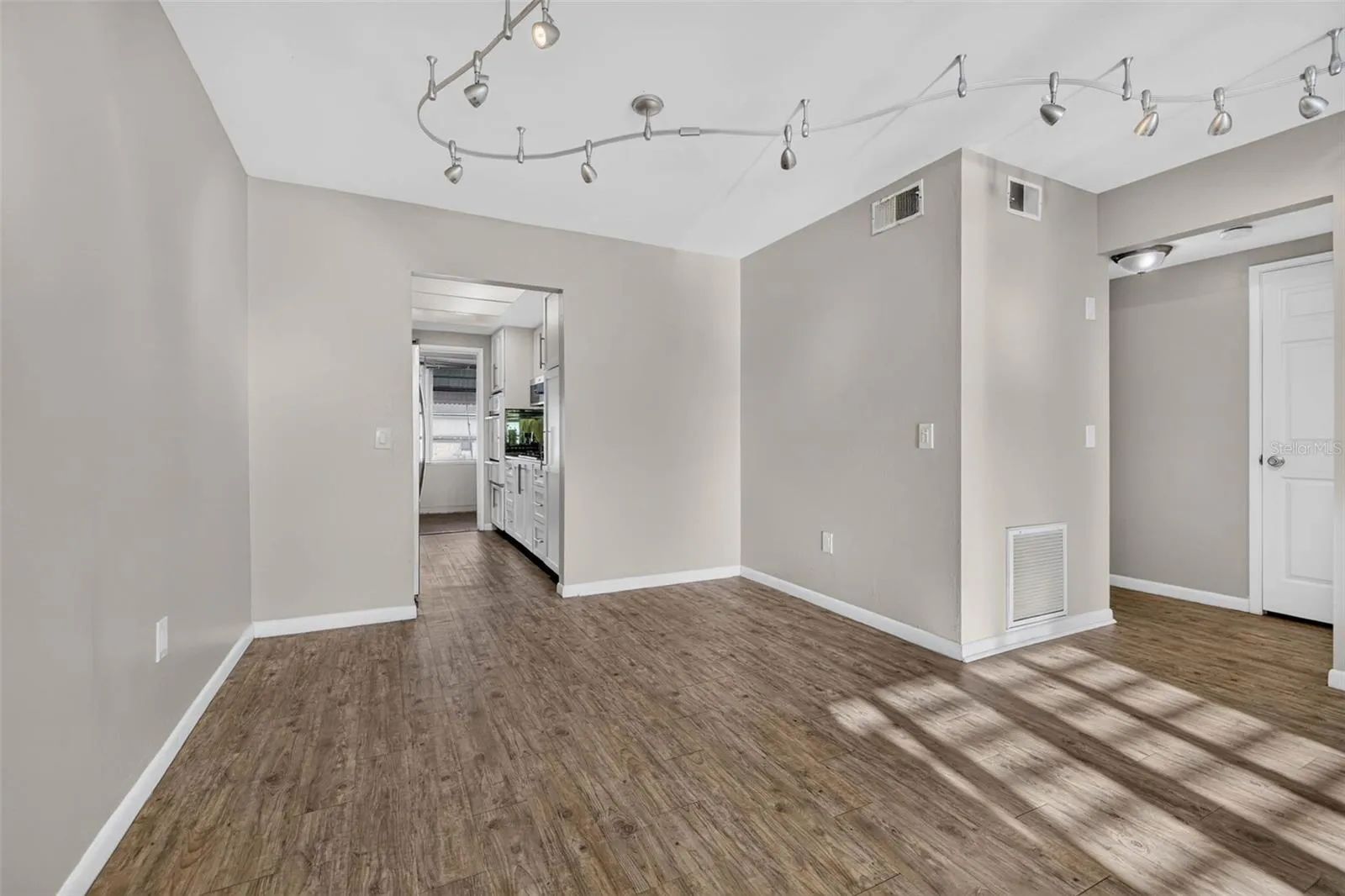 Neutral paint, and an open layout that flows seamlessly into the kitchen.