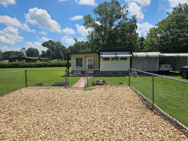 Front of home, parking area for company.