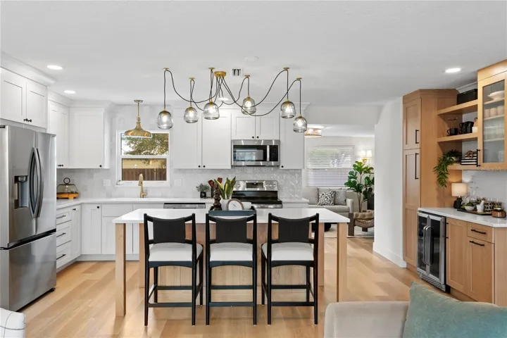 The eat-in kitchen features quartz countertops with dual side seating and stainless steel appliances.