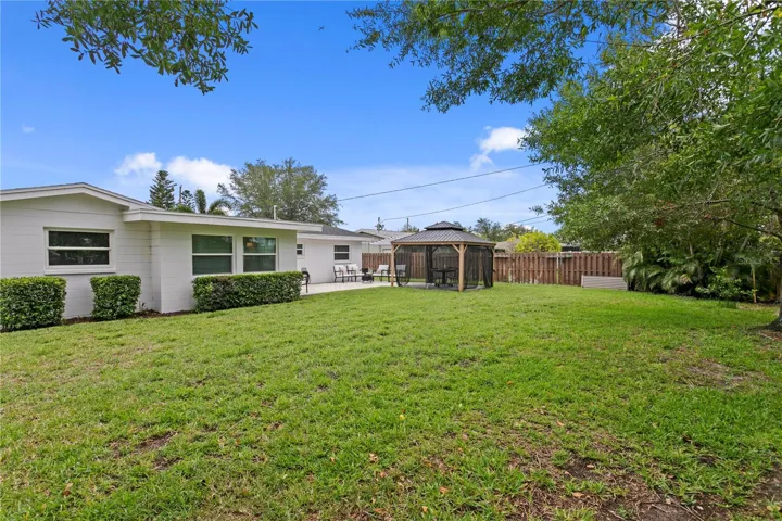 Step out back to this peaceful and spacious backyard.