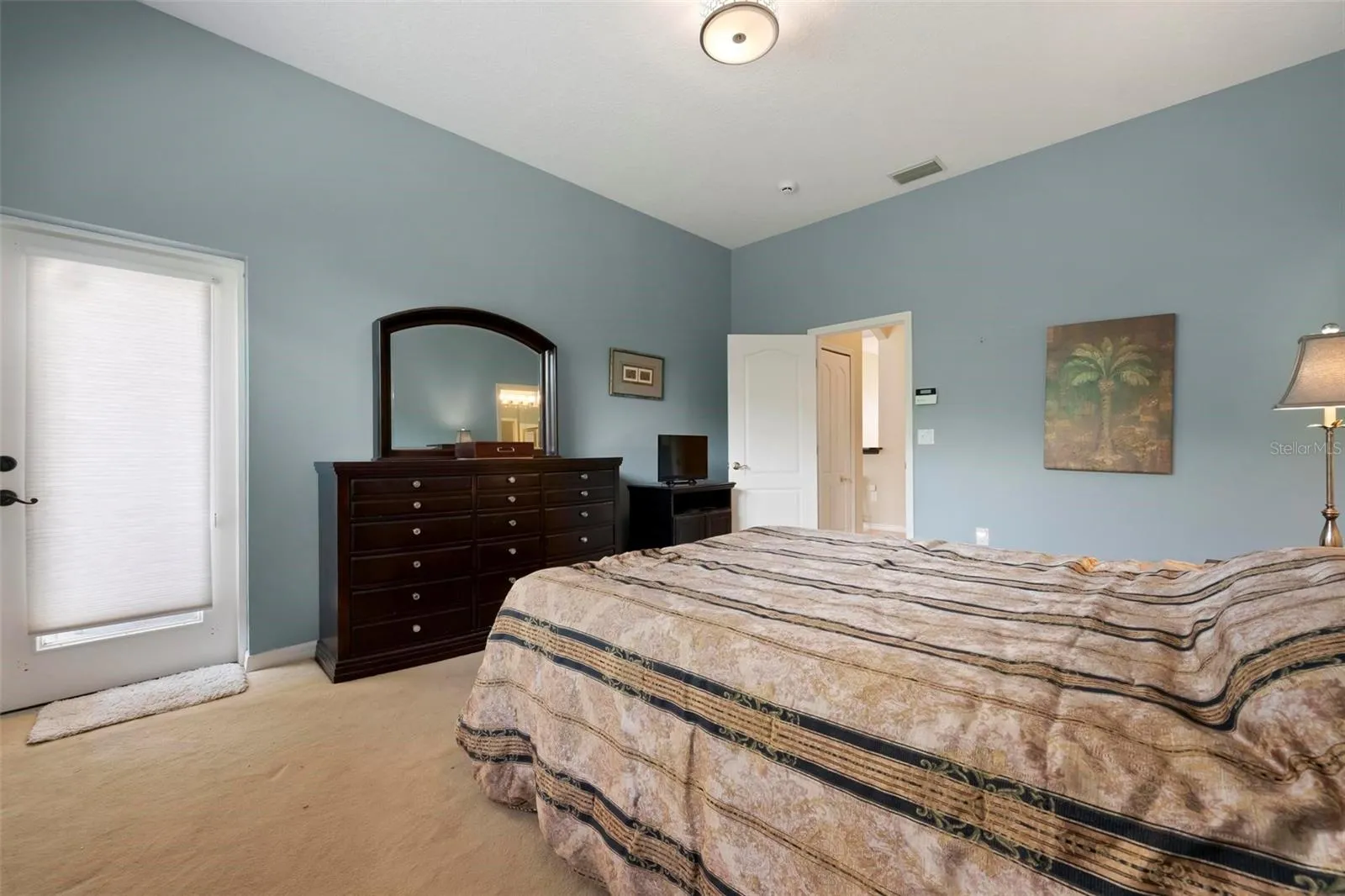 Primary bedroom with entrance to hall in background