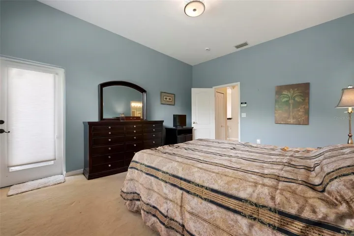 Primary bedroom with entrance to hall in background