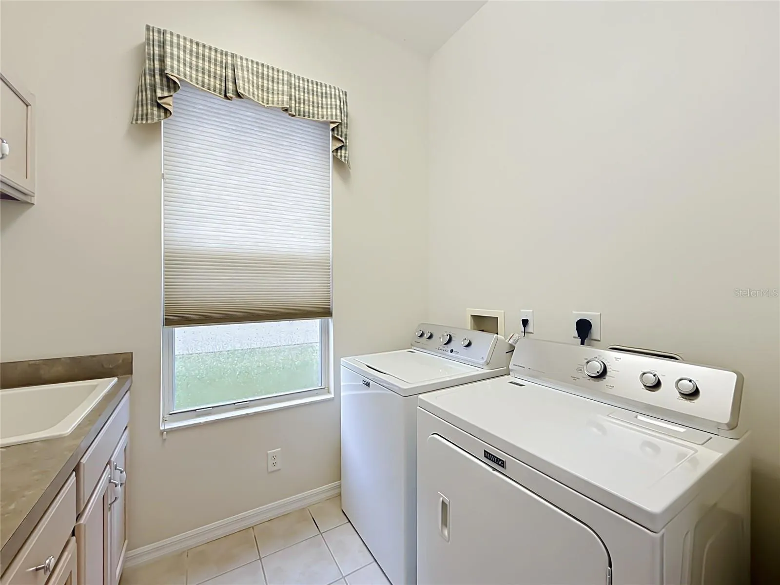 Laundry room, with cabinets and laundry sink. Gas dryer option