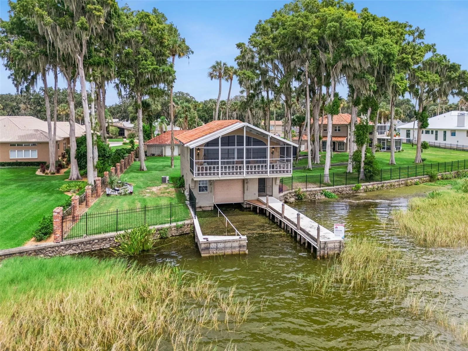 Private dock with covered boathouse on Lake Harris, one of Central Florida's premier boating lakes
