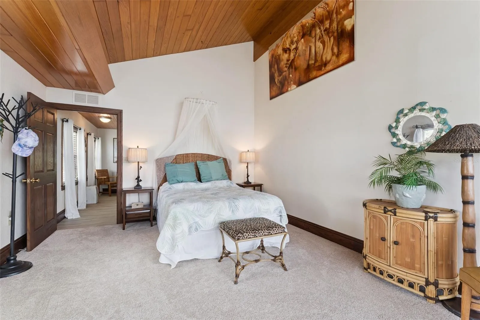 Romantic guest suite with wood ceiling and French-inspired details