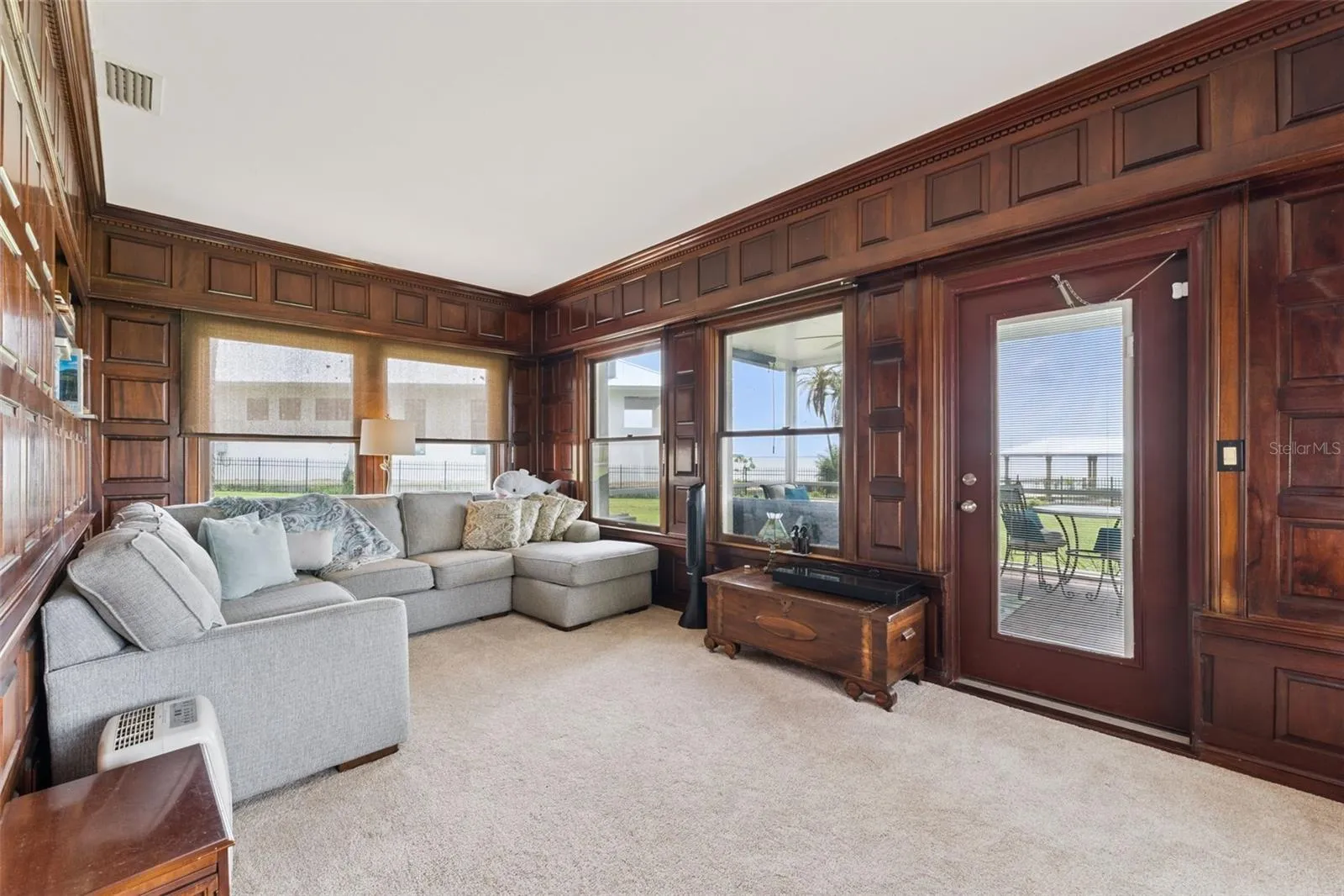 Family room opens to the screened porch and lake views beyond