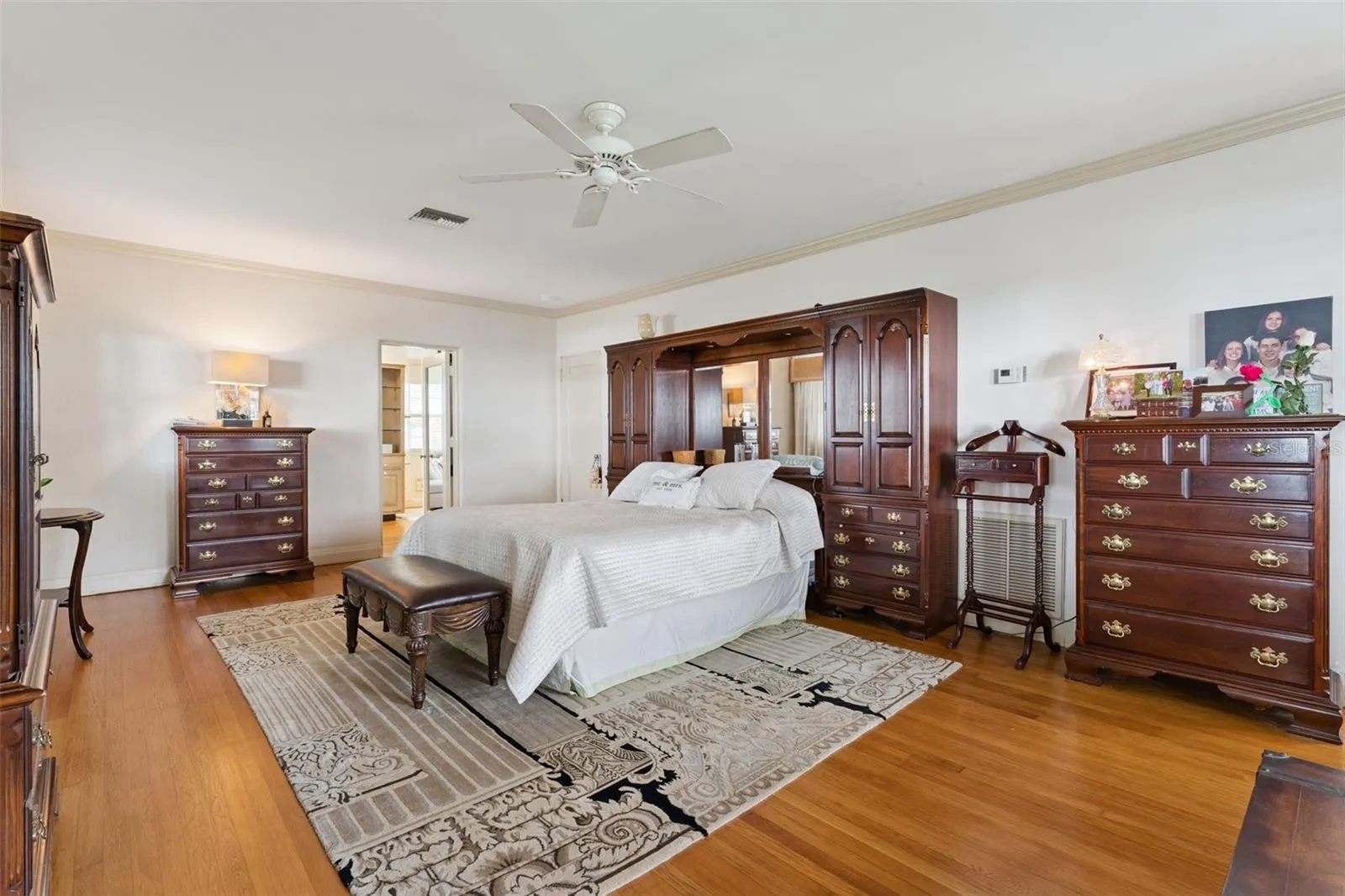 Expansive primary suite with warm wood ceiling and room for a king-size retreat