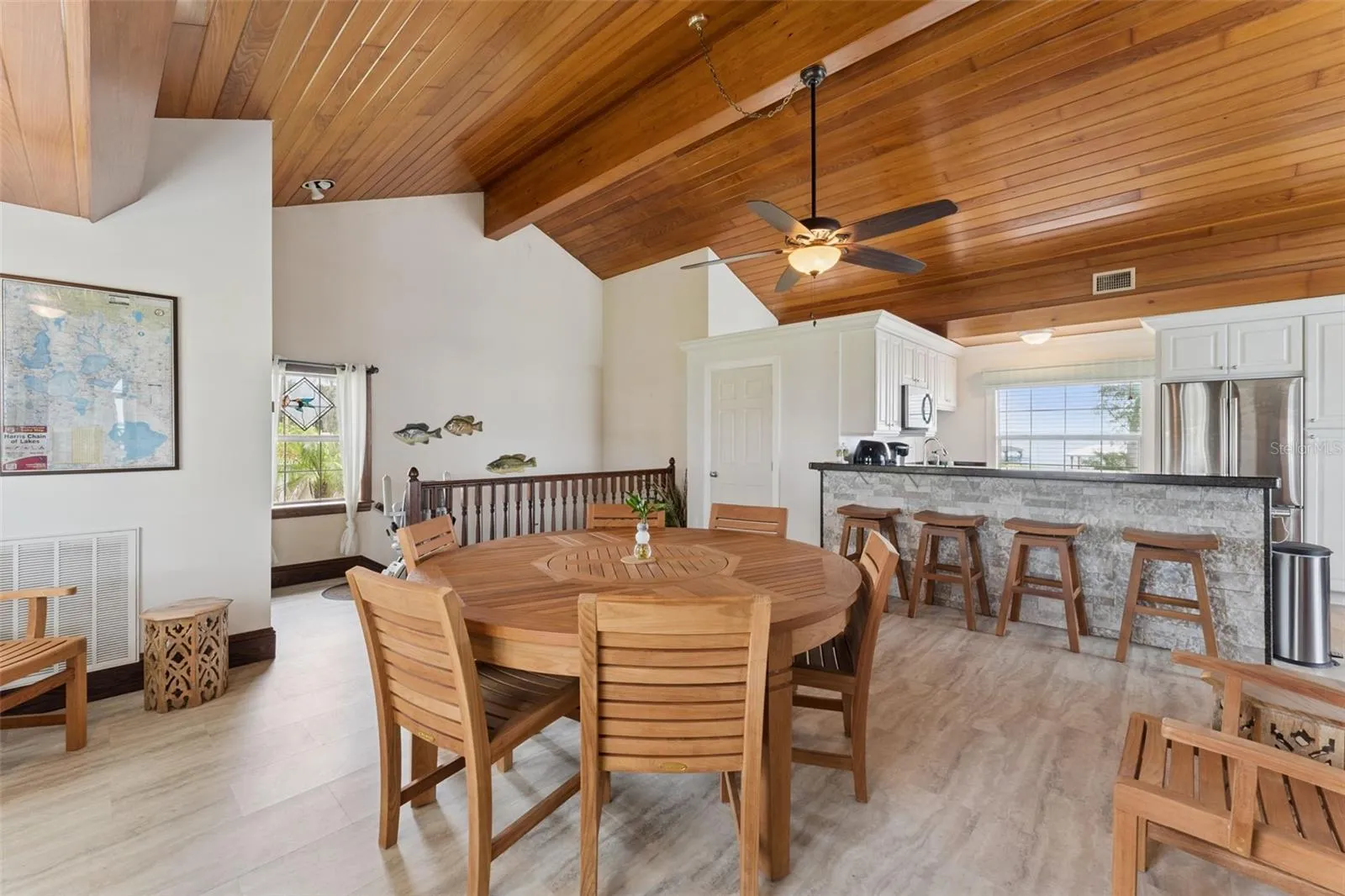Breakfast bar and dining nook with warm wood tongue-and-groove ceiling