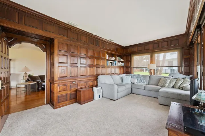 Handsome wood-paneled family room with built-ins and room for the whole family