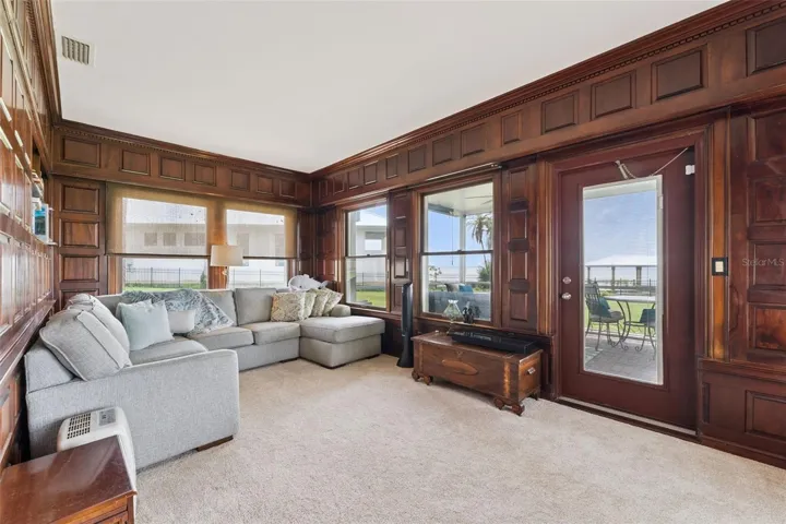 Family room opens to the screened porch and lake views beyond