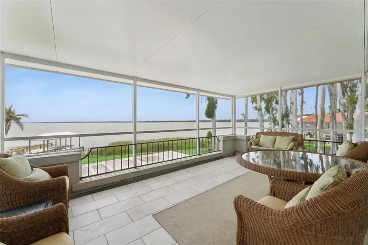 Upper screened balcony with rocking chairs and endless lake views