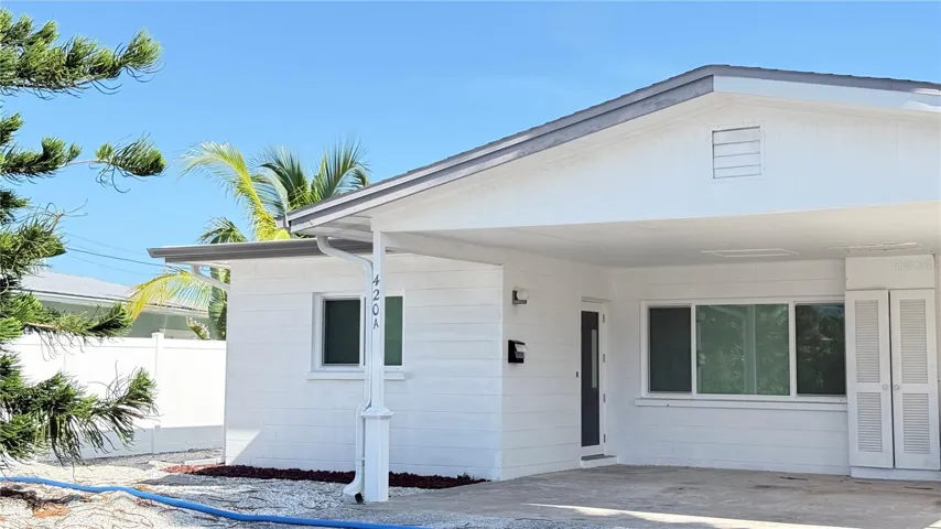 Exterior of Unit showing covered parking area and main entry door