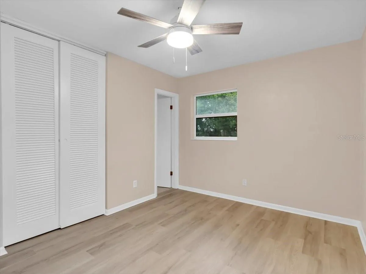 Primary Bedroom, Newer windows. New Fan and Interior Paint and Flooring.
