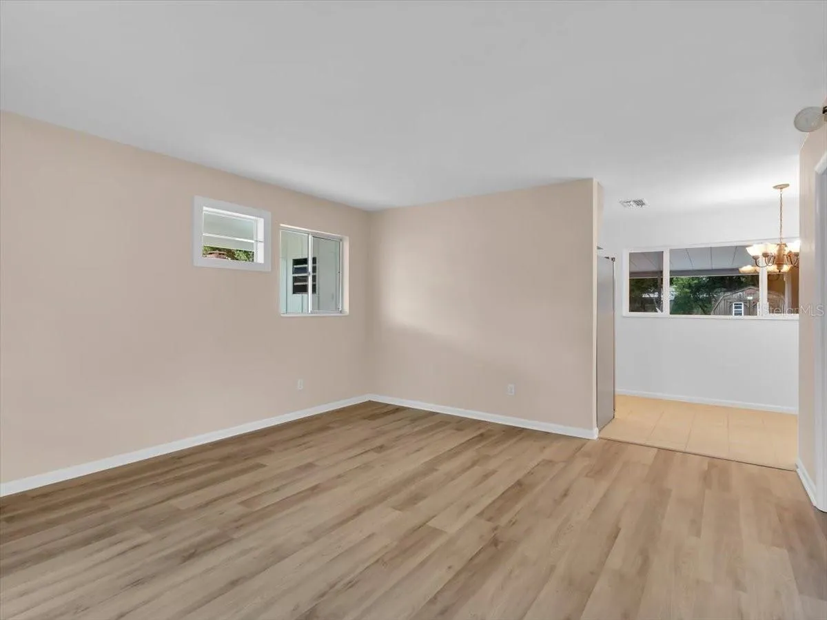 Living room  with room for a larger dining table in the corner.