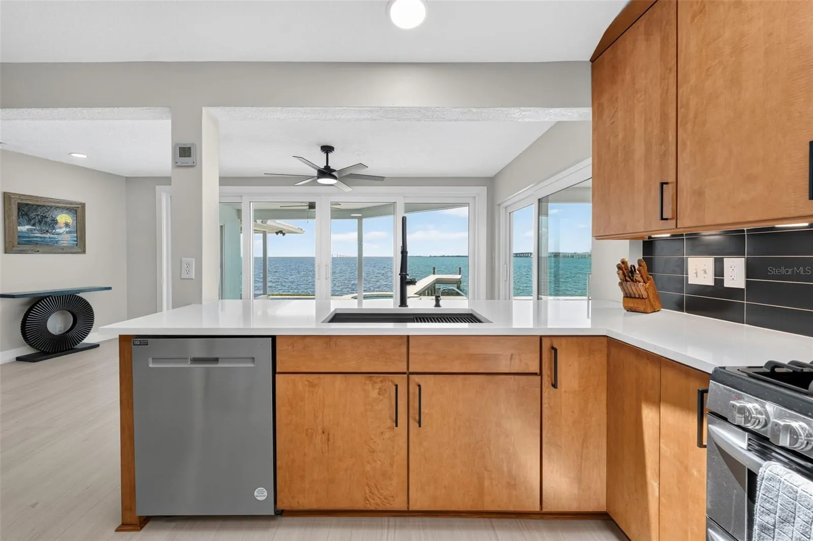 Enjoy abundant natural light and serene water views while cooking or dining in this bright, airy kitchen.