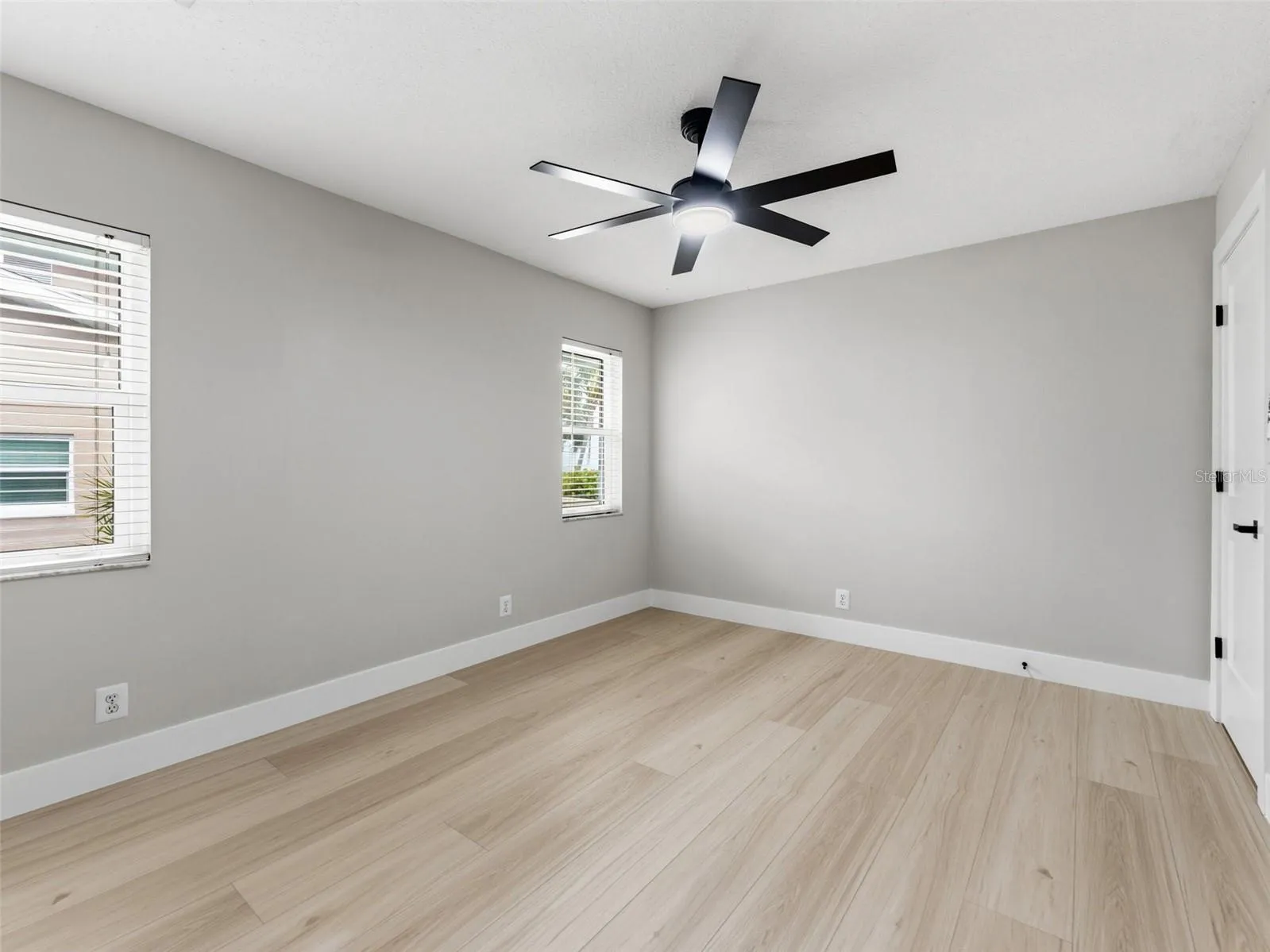 Bedroom 3 with new ceiling fan, fresh paint and baseboards.