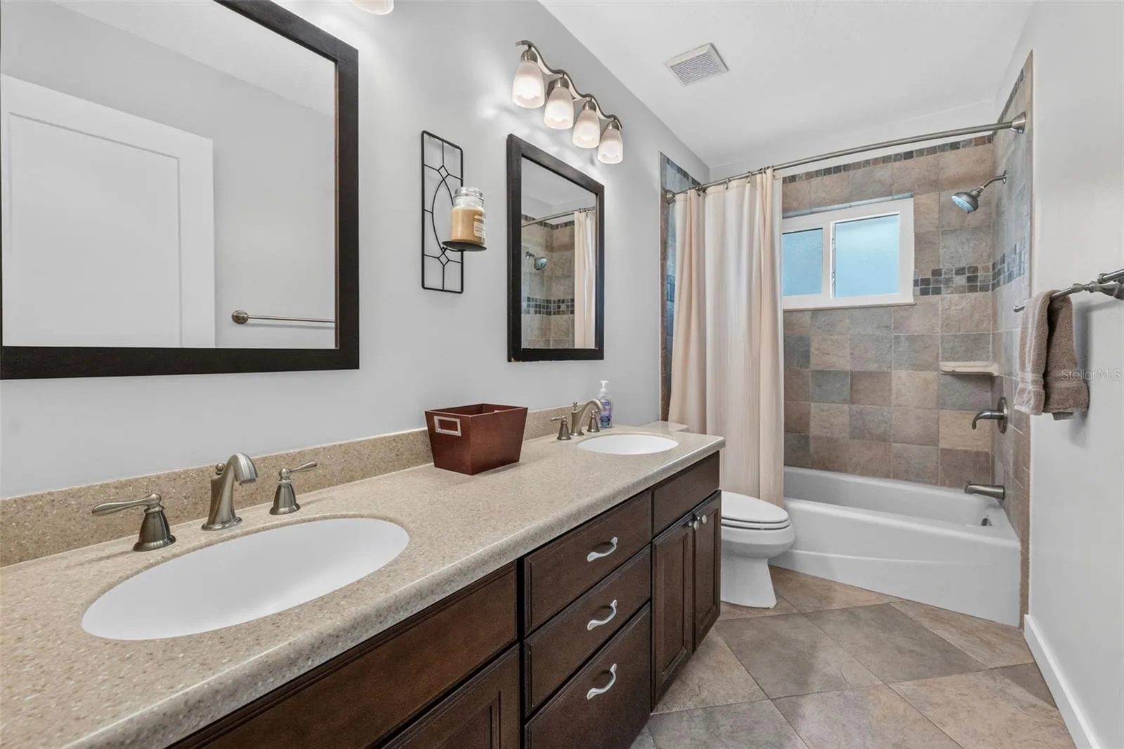 Hall bathroom featuring a large double vanity, perfect for family use and morning routines.