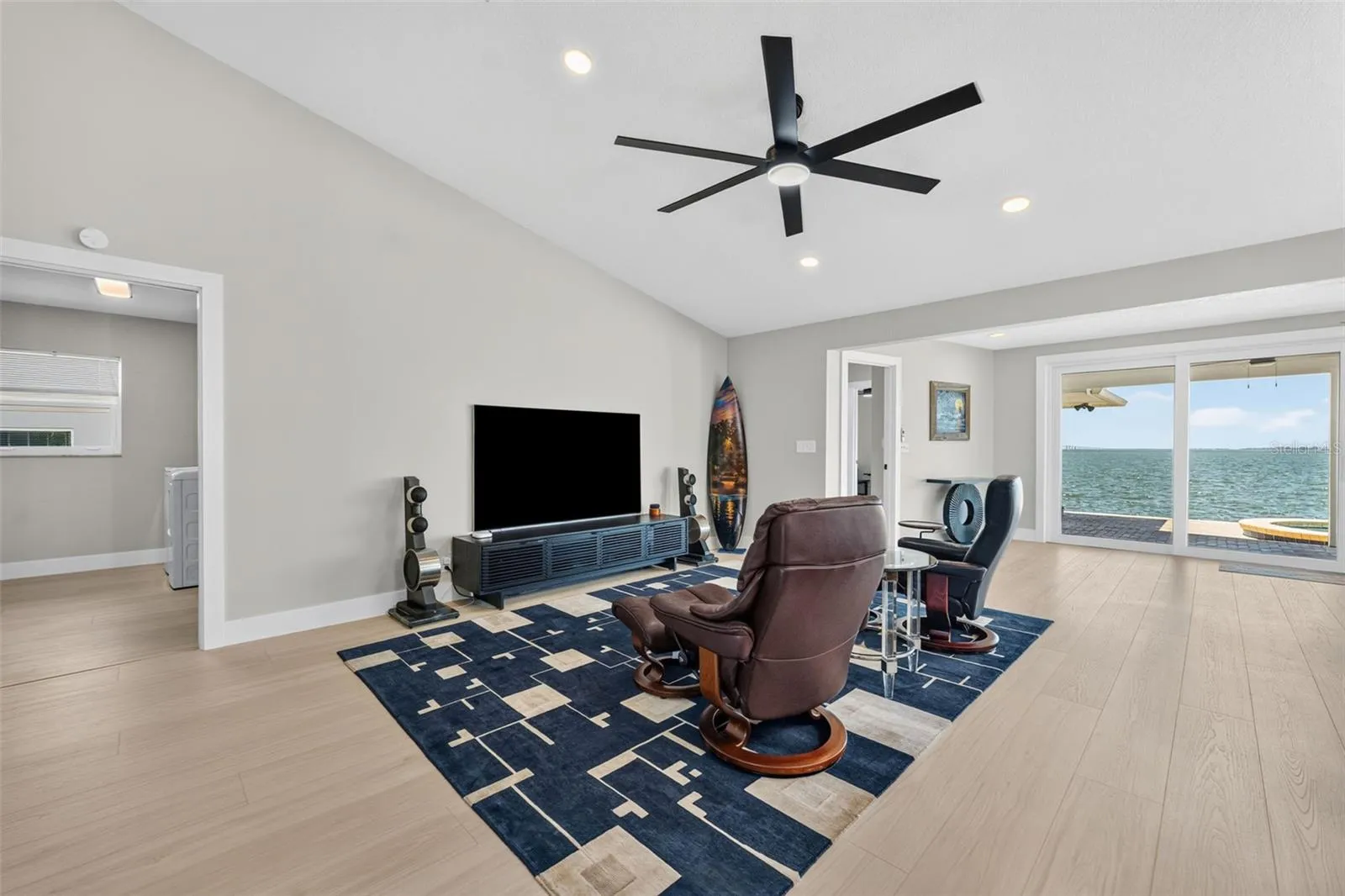 Spacious family room featuring vaulted ceilings and recessed lighting for an open, airy feel.