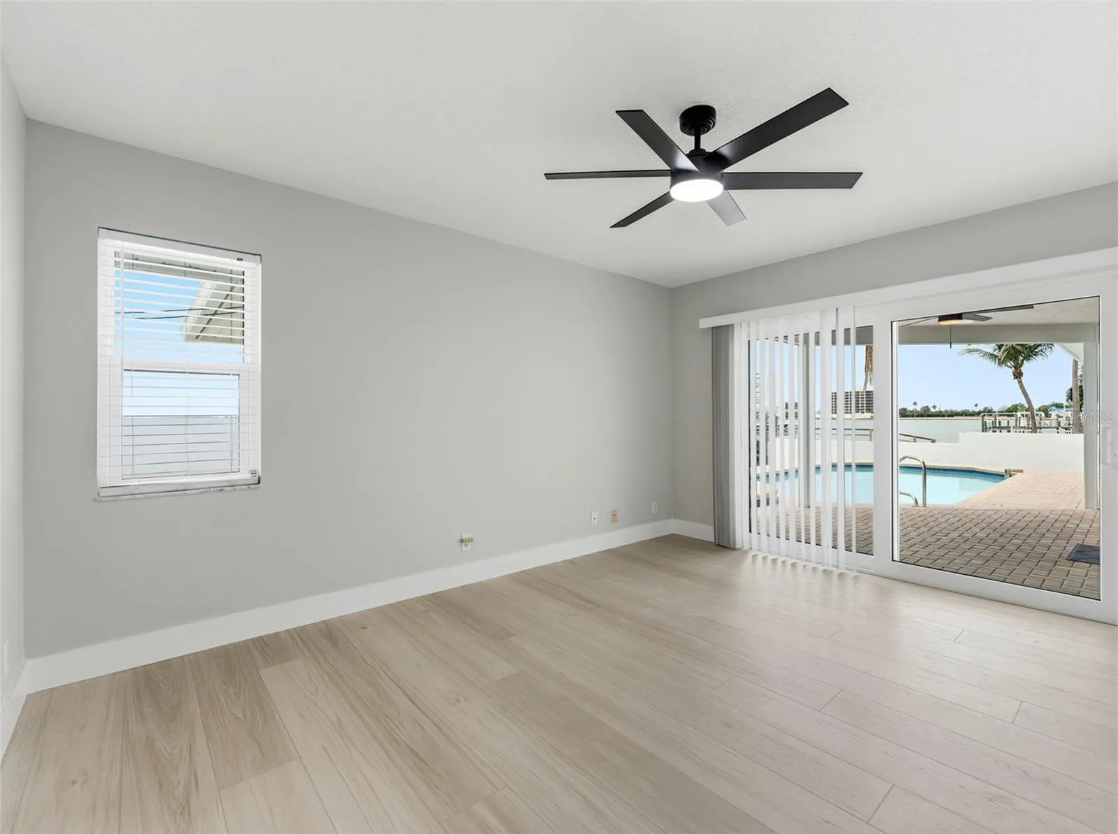 Bedroom 4 with sliding glass doors leading to the pool deck