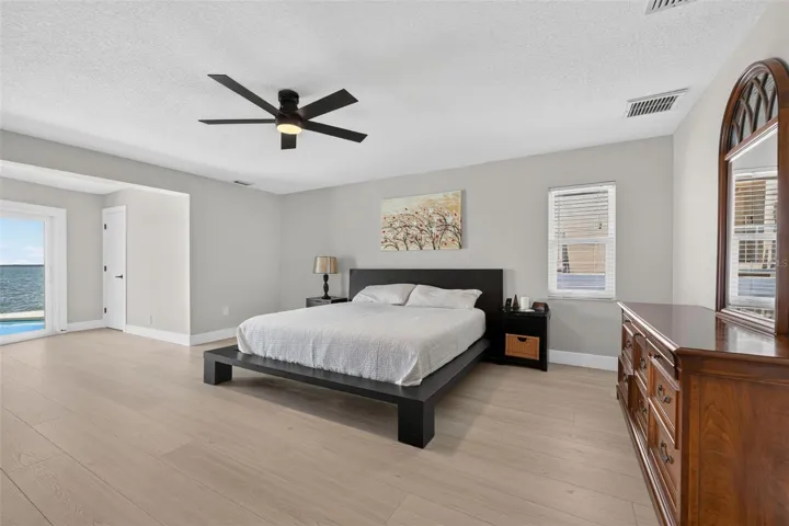 Spacious primary bedroom with new luxury vinyl plank flooring, offering plenty of room for all your furniture and personal touches.