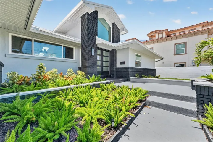 Beautifully landscaped walkway creates a warm and inviting entrance to the home.