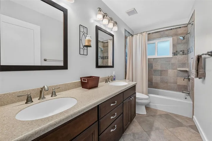 Hall bathroom featuring a large double vanity, perfect for family use and morning routines.