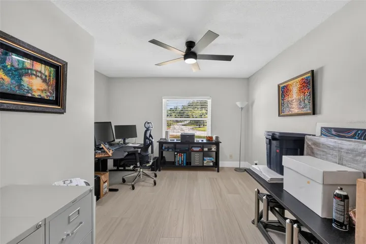Bedroom 2 featuring luxury vinyl plank floors, offering a bright and inviting space for family, guests, or as an office.