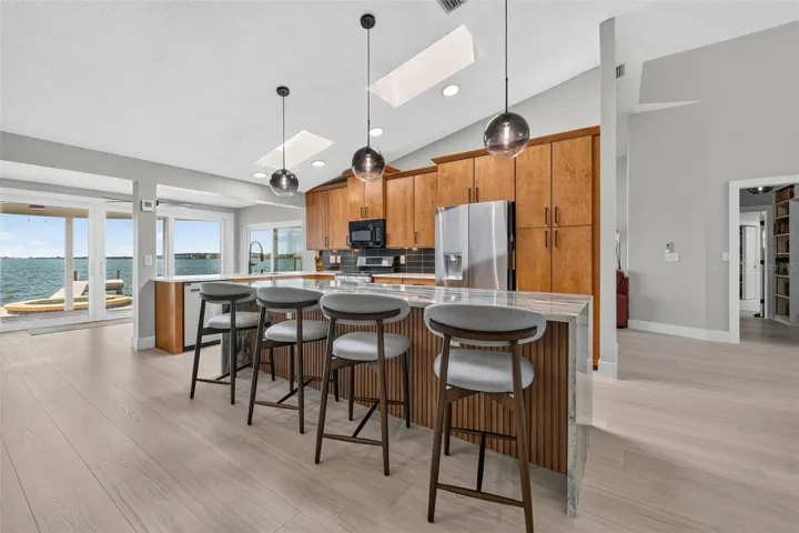 Bar seating at kitchen island with sleek pendant lighting