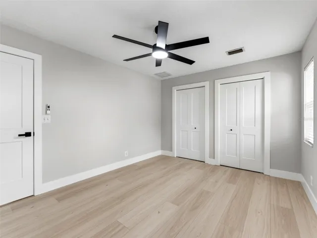 Bedroom 4 with custom closets by closet by design.