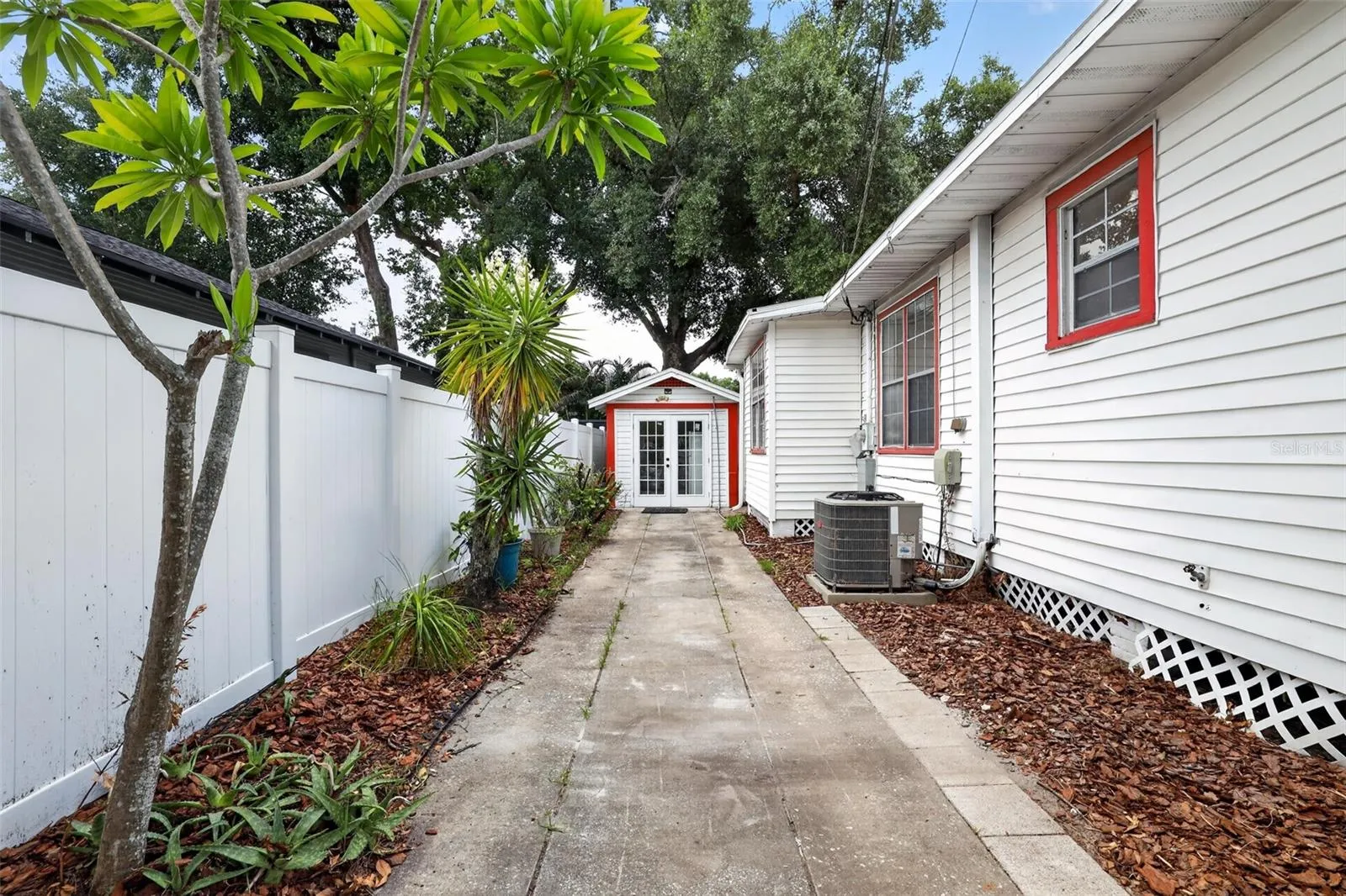 Private side walkway leading to the detached garage in this 1922 bungalow