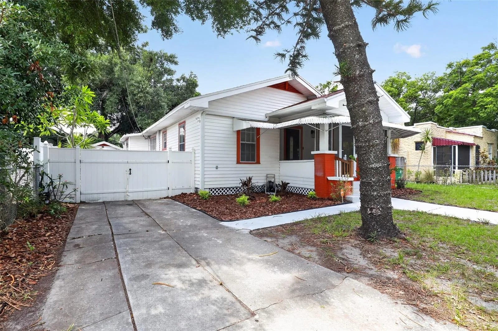 Side view of this classic 1922 bungalow showing the driveway and inviting curb appeal