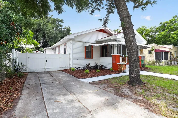Side view of this classic 1922 bungalow showing the driveway and inviting curb appeal