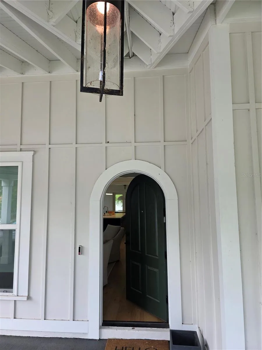 Beautifully detailed board and batten exterior with unique arched entry door