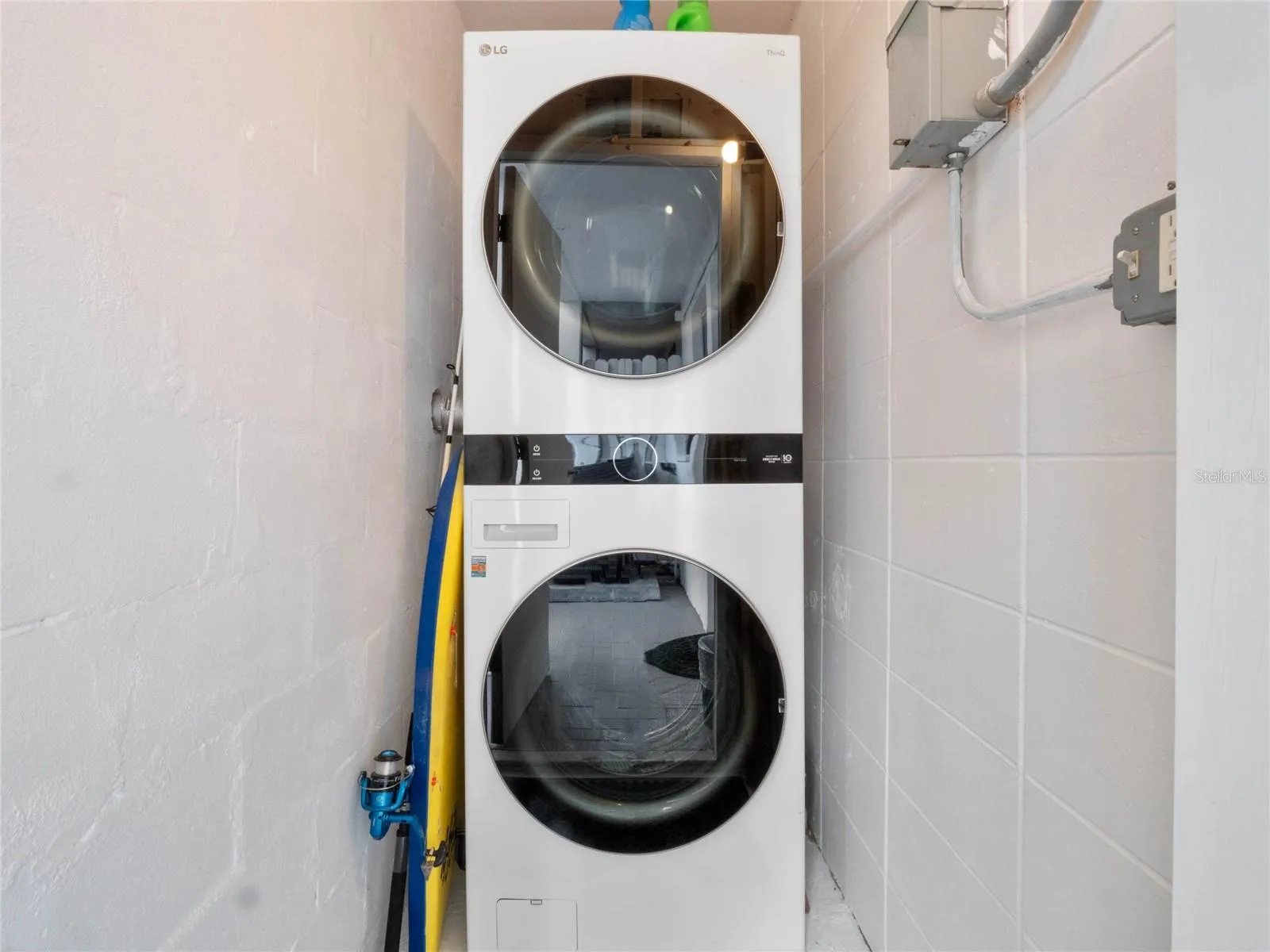 Convenient interior laundry area with stacked washer and dryer included.