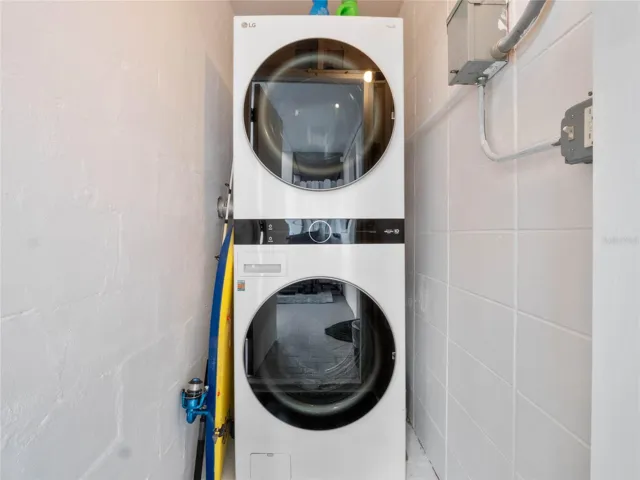 Convenient interior laundry area with stacked washer and dryer included.