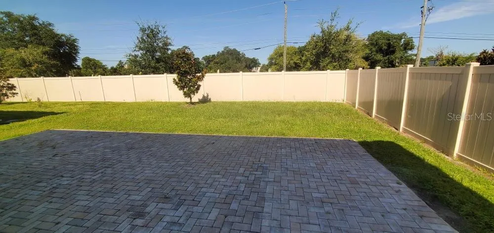 VIEW TO PATIO AND REAR YARD FROM LIVING ROOM/DINING AREA & KITCHEN