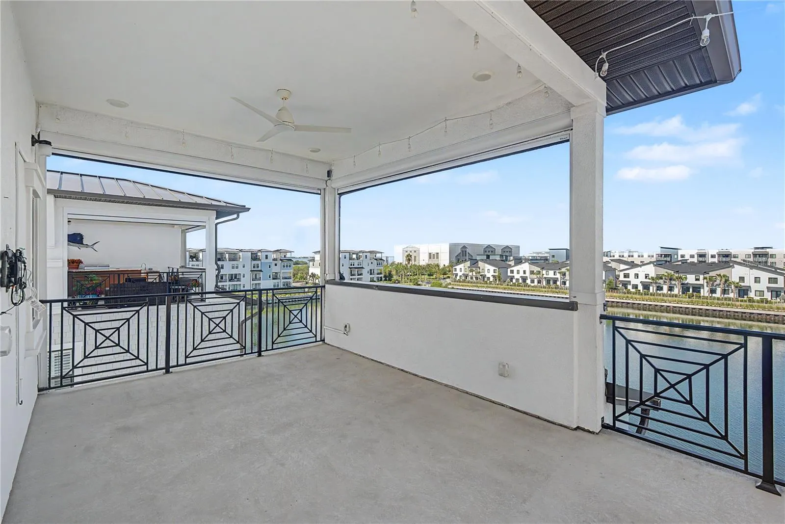 Fourth-level private patio with an inviting outdoor seating area and expansive, seemingly endless water views.