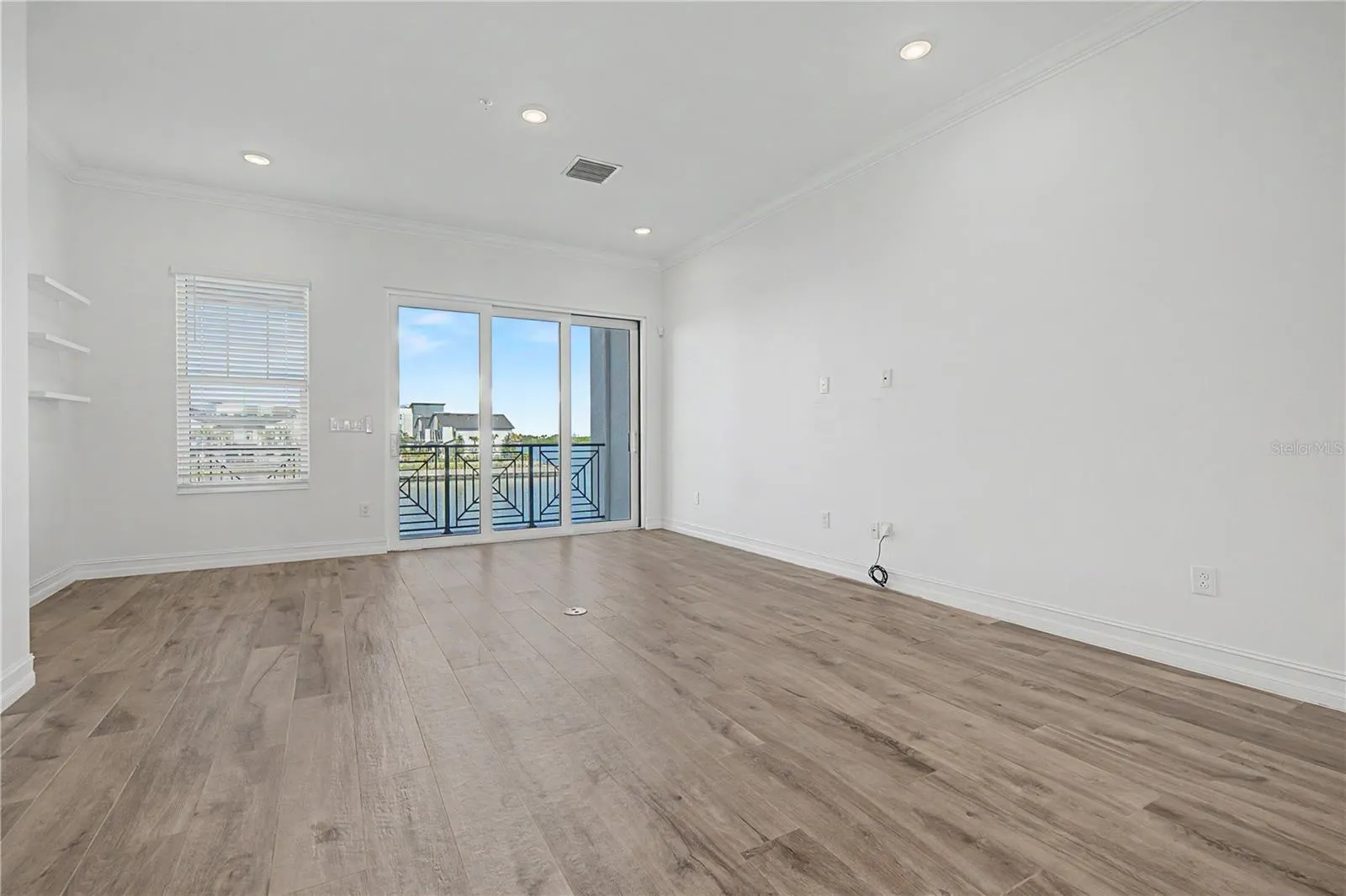 Second-level living area with a bright, open, and inviting feel straight to sliding doors that lead to an amazing outdoor patio.